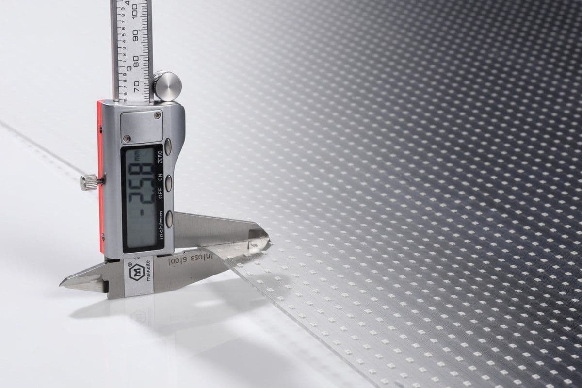 Digital caliper measuring the millimetre-thin profile of transparent LED film