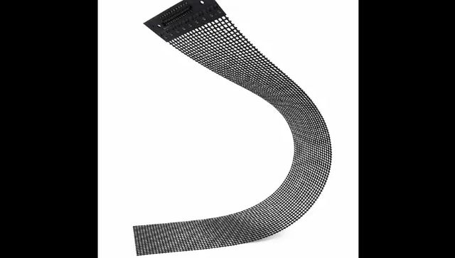 A strip of micro-mesh transparent LED film bent into an S curve, showing how flexible it is