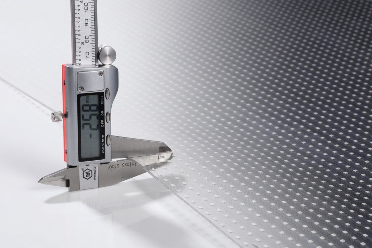 Digital caliper measuring the millimetre-thin profile of transparent LED film