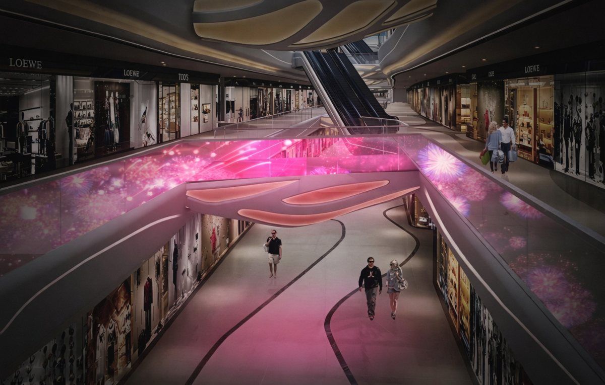 Mall interior with adhesive LED film on glass balustrades showing pink visuals